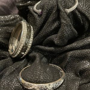 Three silver-tone bracelets/bangles, with rhinestone accents.